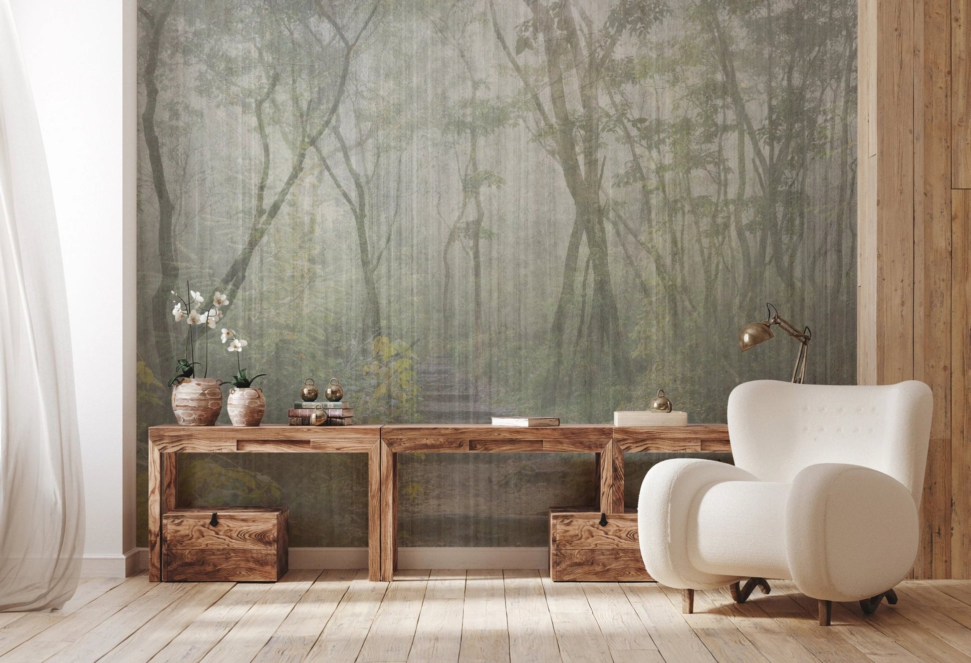 Forest scenery wall mural with a rustic wooden console table and white armchair.