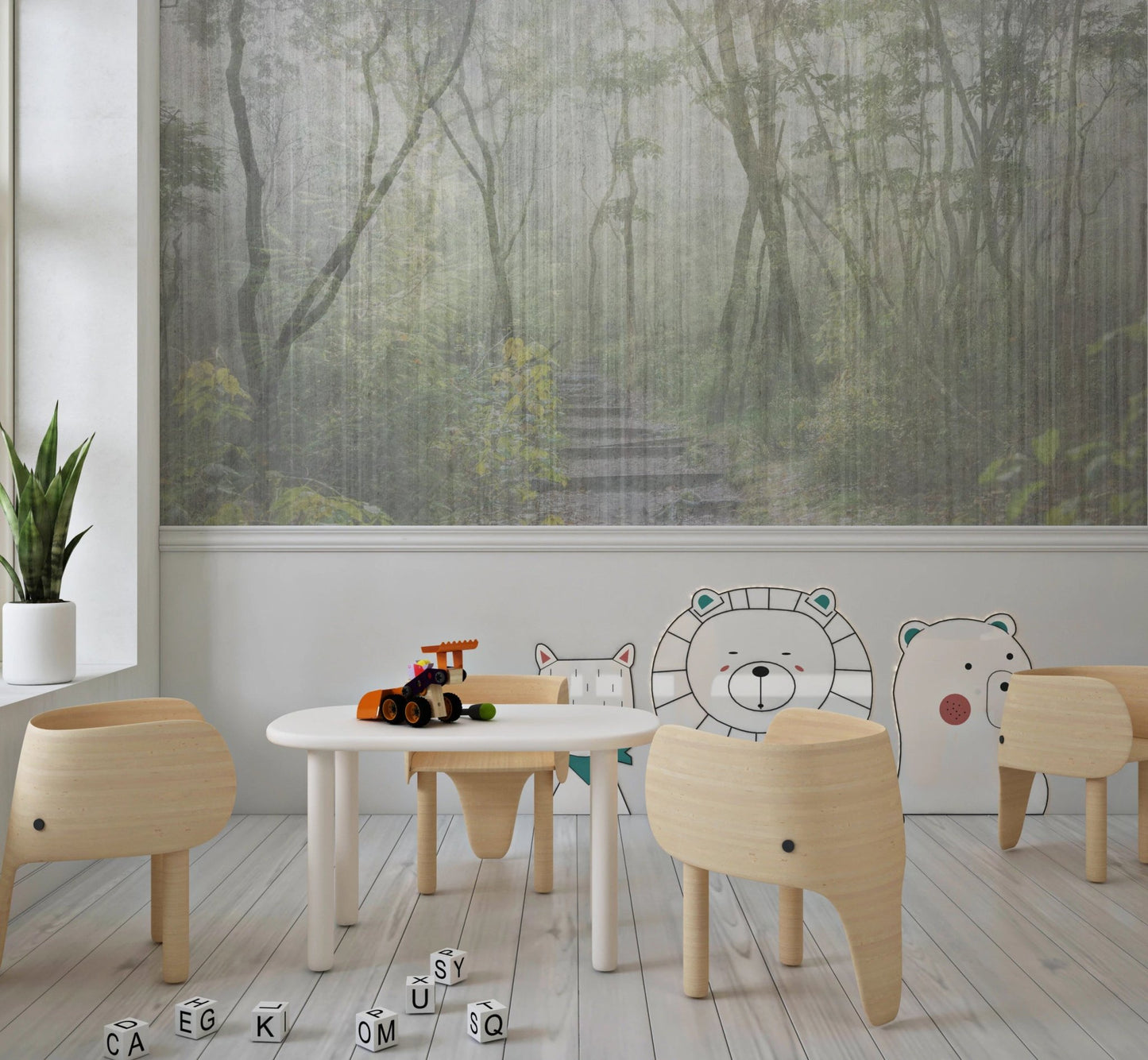 Kids play area with a forest wall mural behind small white tables and chairs.