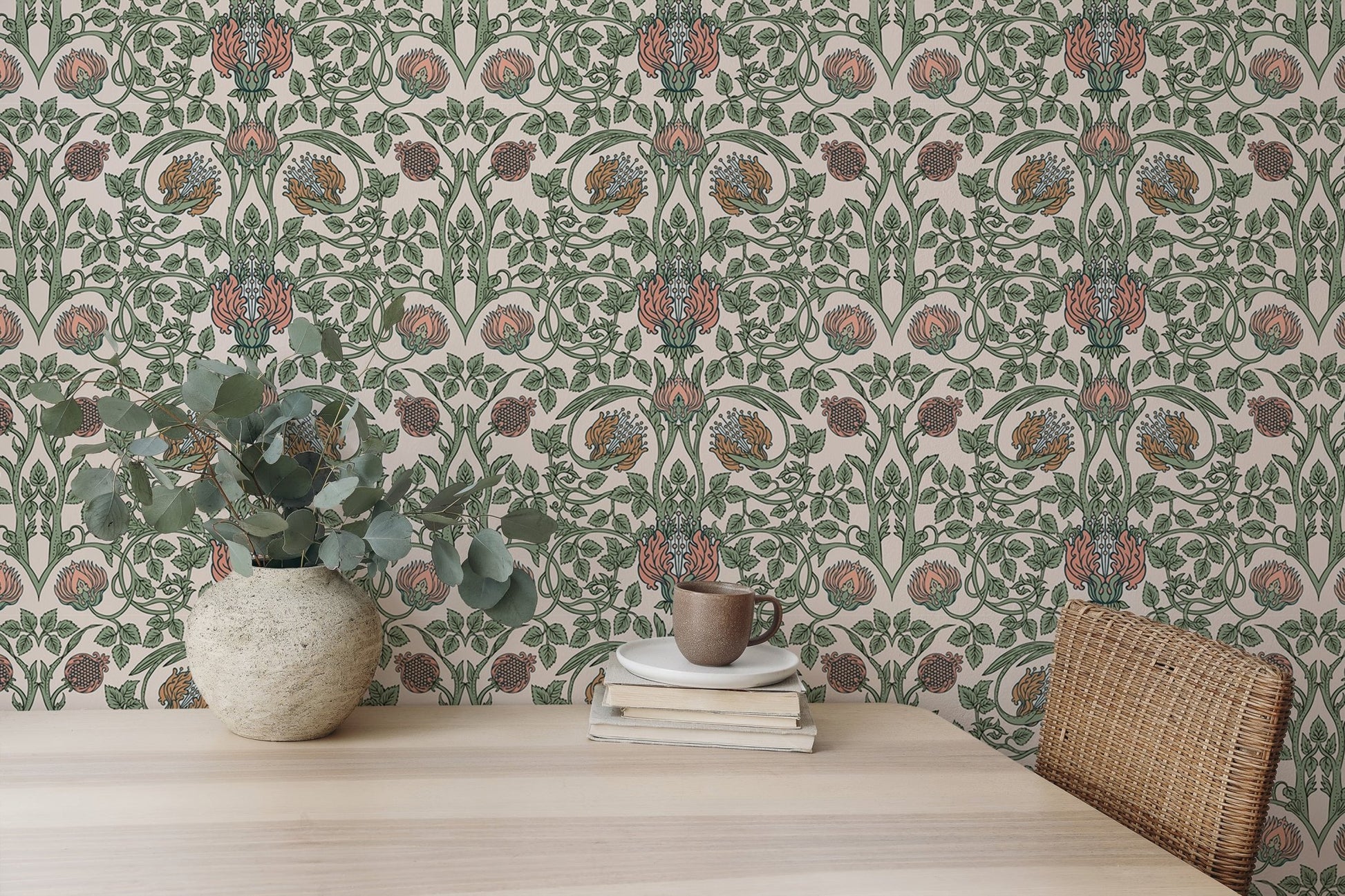 Symmetrical floral pattern wall mural behind a light wood desk and green plant.
