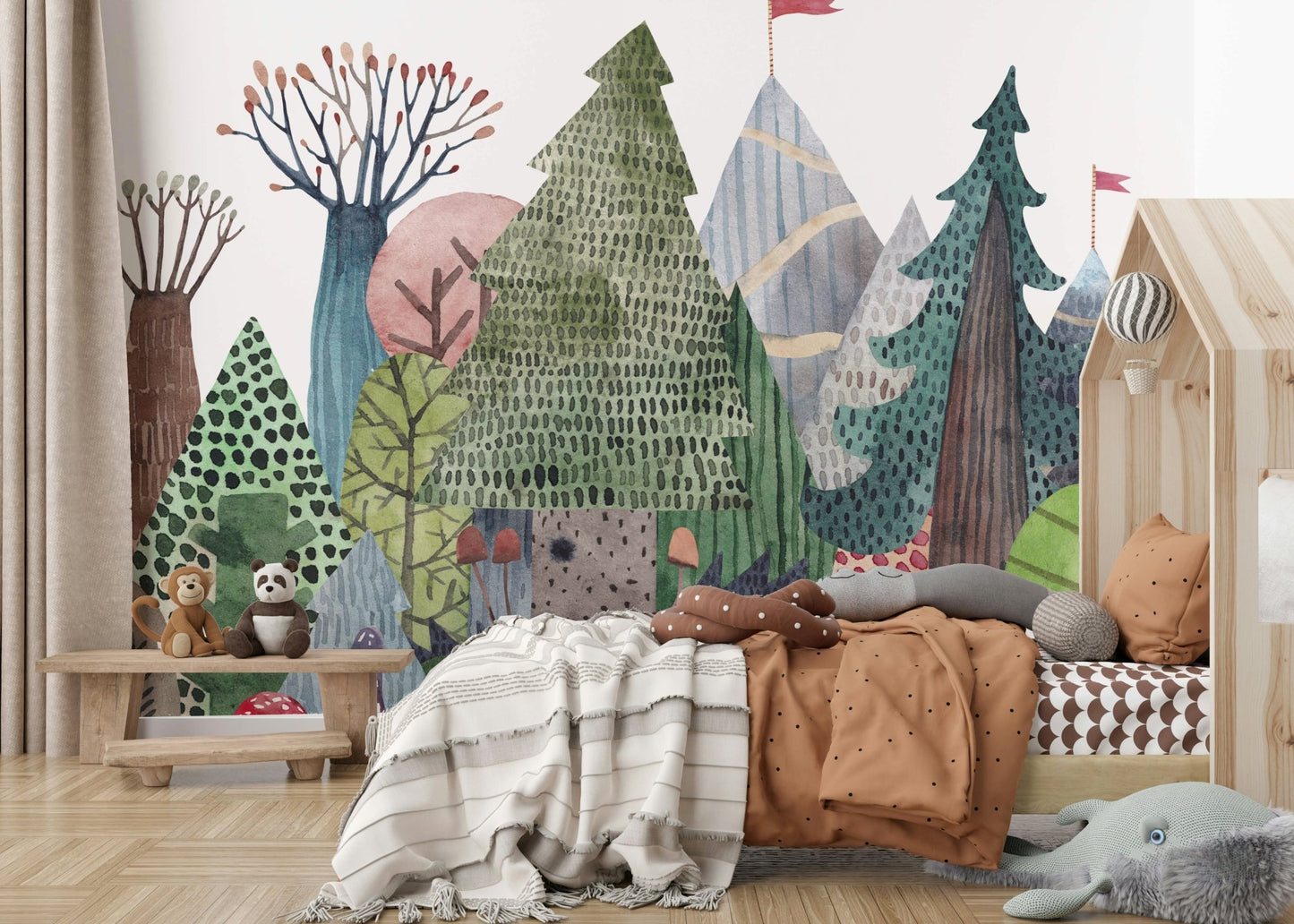 Woodland scene wallpaper in a gender-neutral nursery.