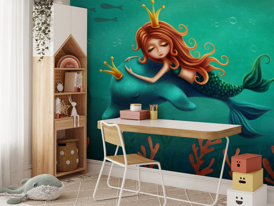 Mermaid and dolphin wall mural in a kids study area with a wooden desk.