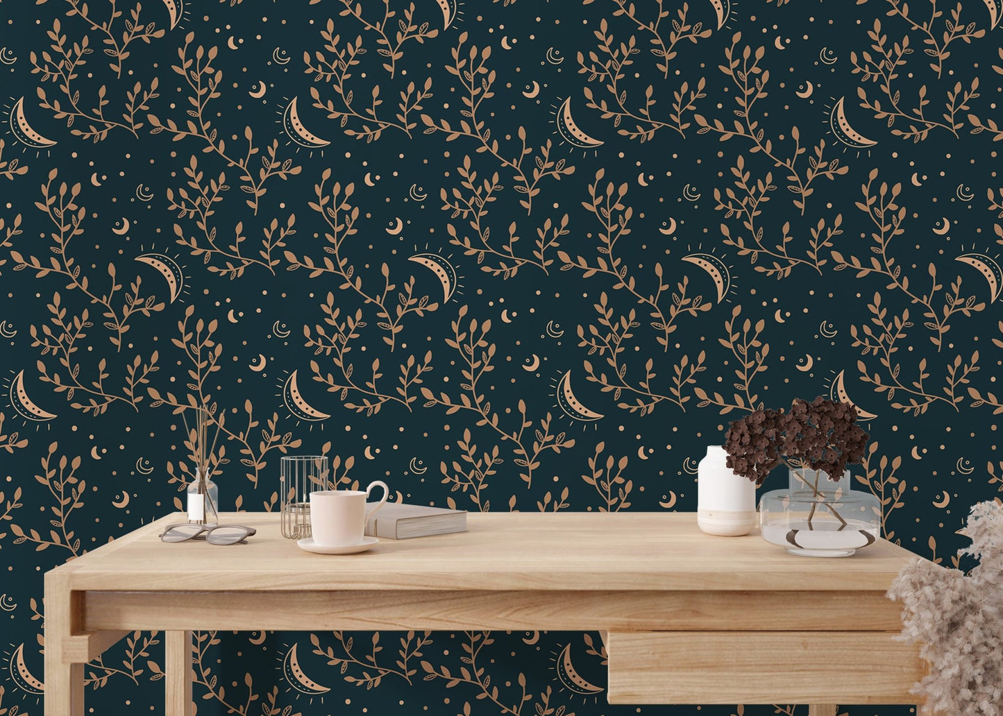 Minimalist desk with stationary and dark teal floral moon wallpaper backdrop.