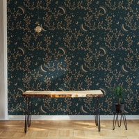 Entryway console table with gold celestial patterns on a floral wallpaper