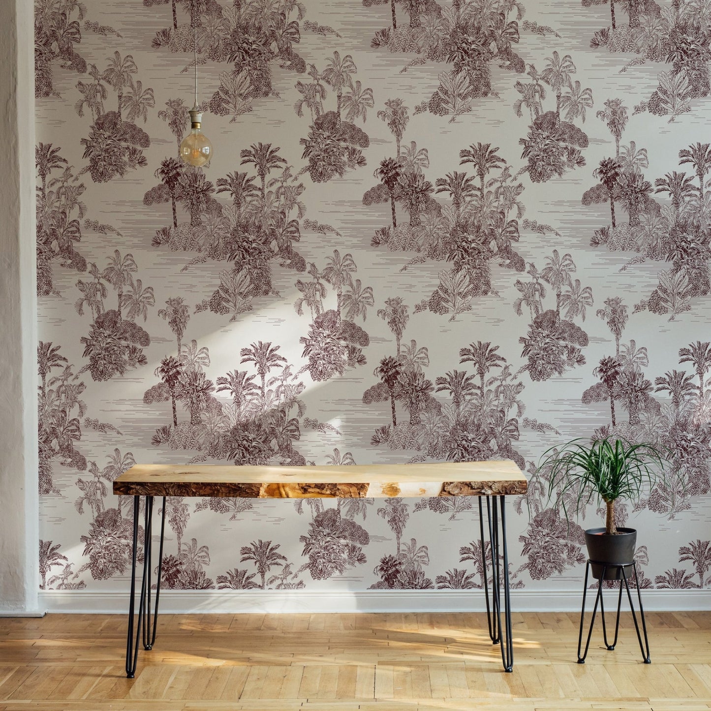 Etching Tropical Jungle Pattern Brown Toile Wallpaper behind a rustic wooden desk.