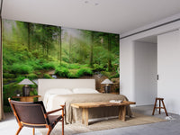 Serene forest paradise wallpaper for a master bedroom with a large bed and side tables.
