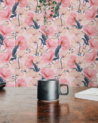 Floral watercolor wallpaper background with a black ceramic mug on a wooden table.