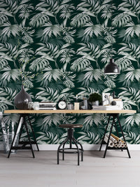 Botanical jungle wallpaper in a home office with a metal desk and stool.
