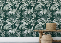 Botanical green wallpaper behind a wooden bench with woven baskets.