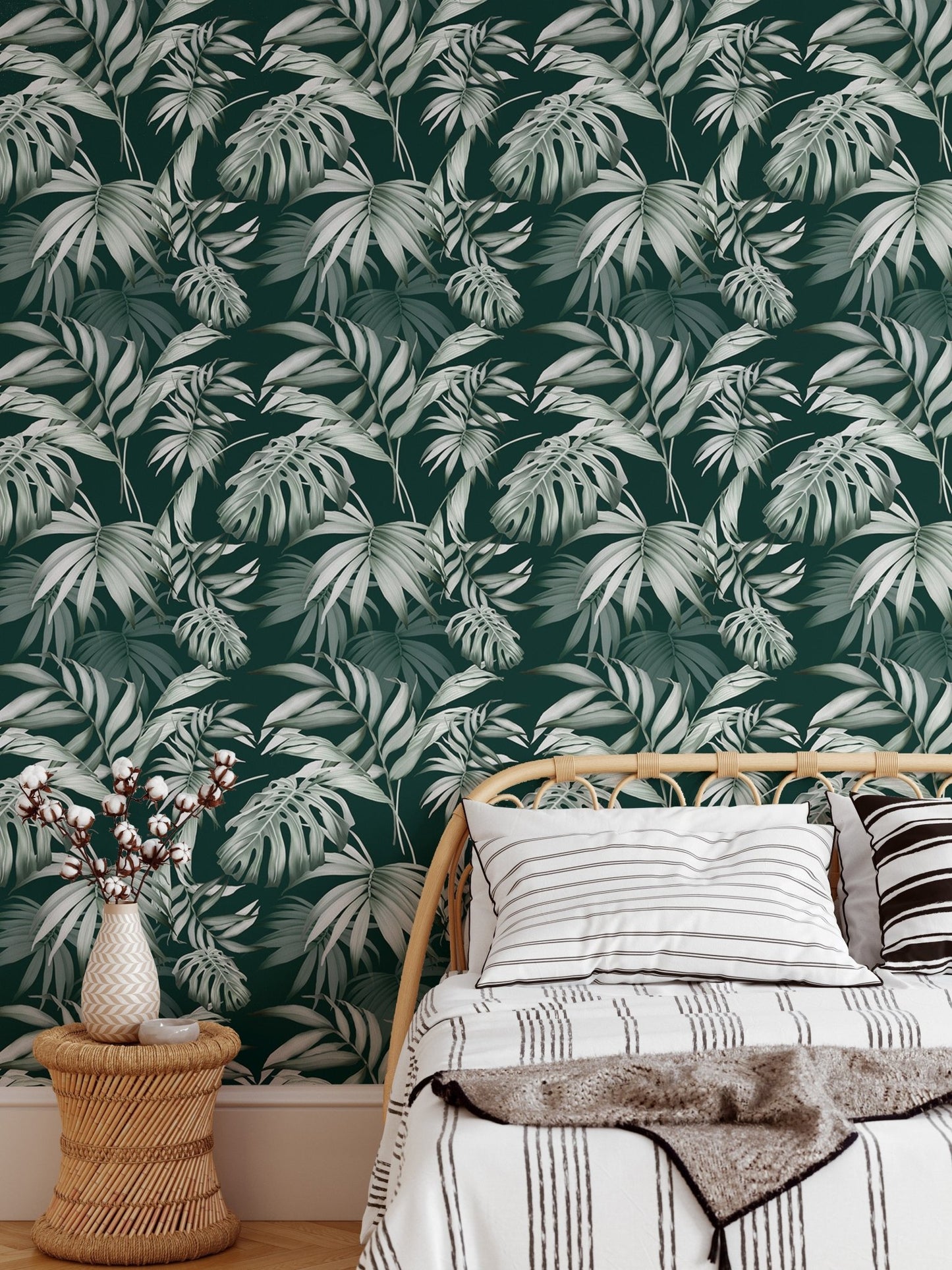 Tropical foliage wallpaper in a child’s room with a small wooden bed.