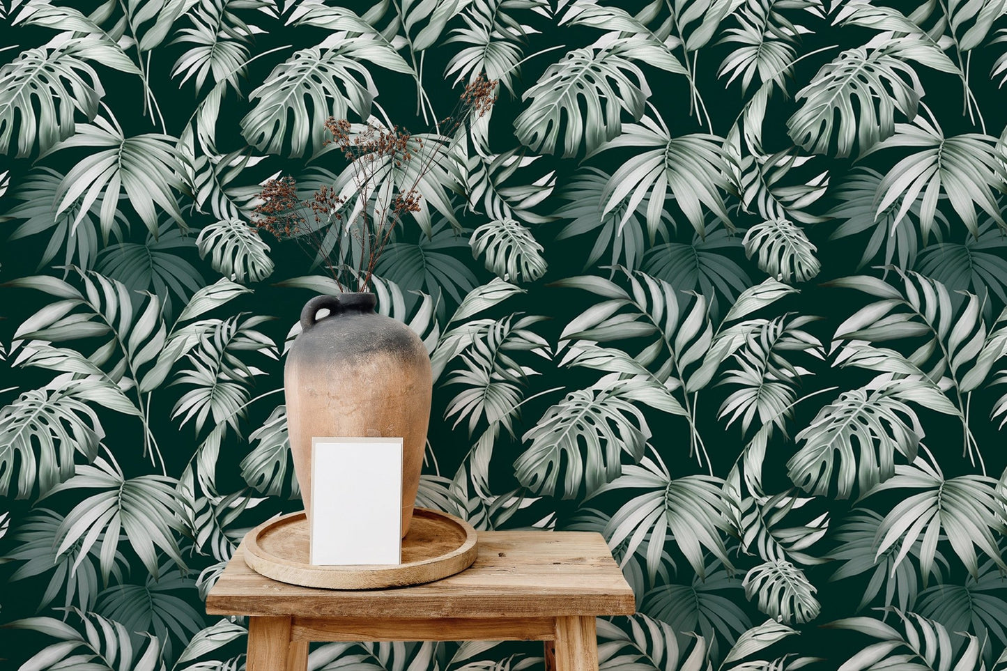 Tropical repeat wallpaper behind a wooden stool and a ceramic vase.