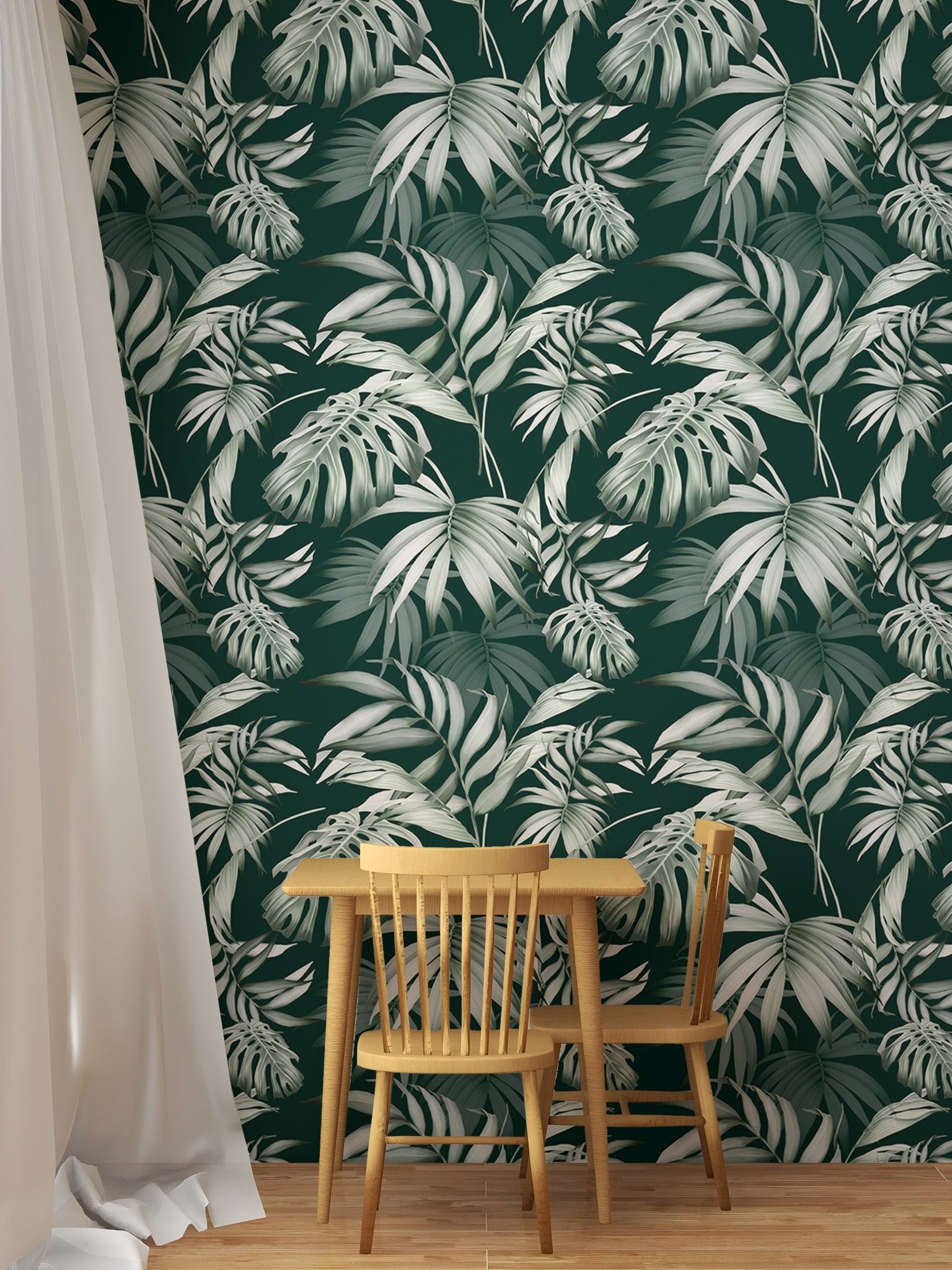 Green tropical wallpaper in a dining area with a round wooden table.