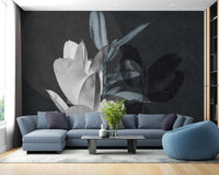 Blue sectional sofa in front of charcoal leaf texture wall mural.