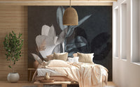 Neutral bedroom with a hanging lamp and leaf texture art wall mural.



