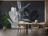 Dining room with wooden table set against exotic leaf wall mural.
