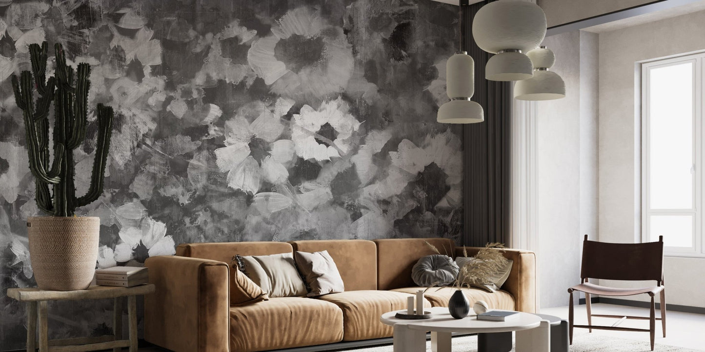 Contemporary living area featuring grey floral wall mural and tan leather couch.