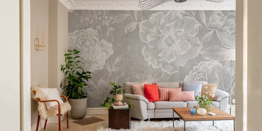 Faded White Floral Delight Wall Murals in a living room with a grey sofa.