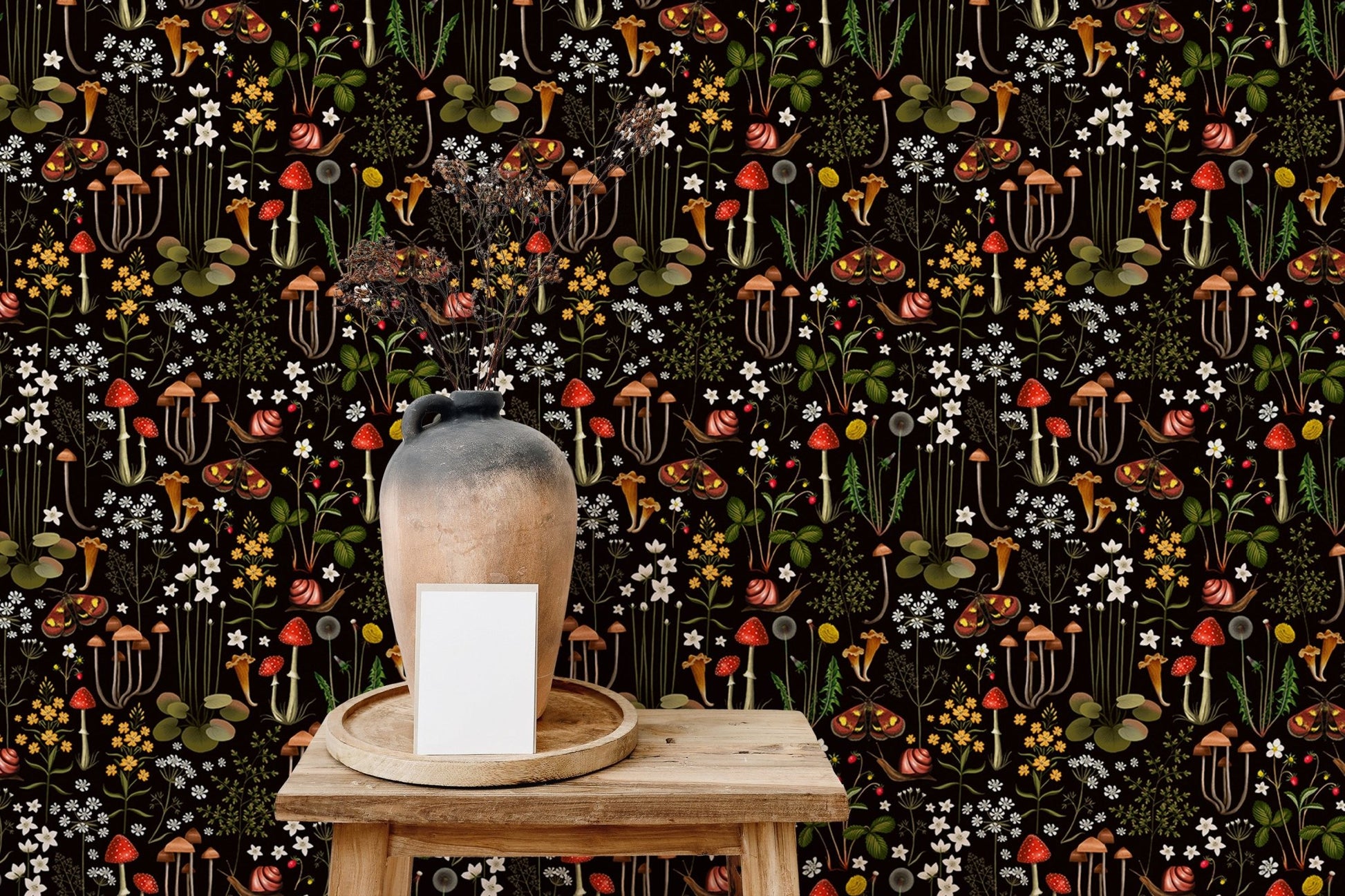 mushroom pattern wallpaper on a small wooden table with a white ceramic vase.