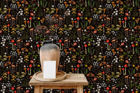 mushroom pattern wallpaper on a small wooden table with a white ceramic vase.