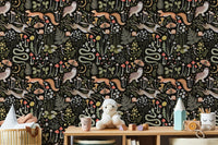 Forest creature wallpaper in a playroom with white toys and shelves.