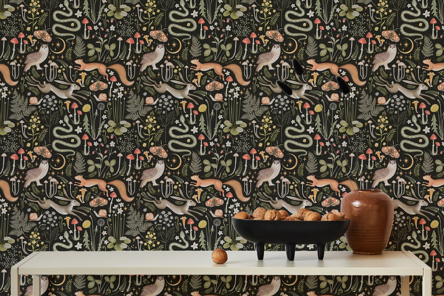 Whimsical forest wallpaper with fairies and dark tones in dining area.