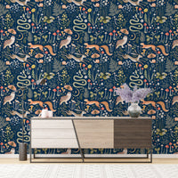 Woodland creature wallpaper on dark blue backdrop above a modern sideboard.