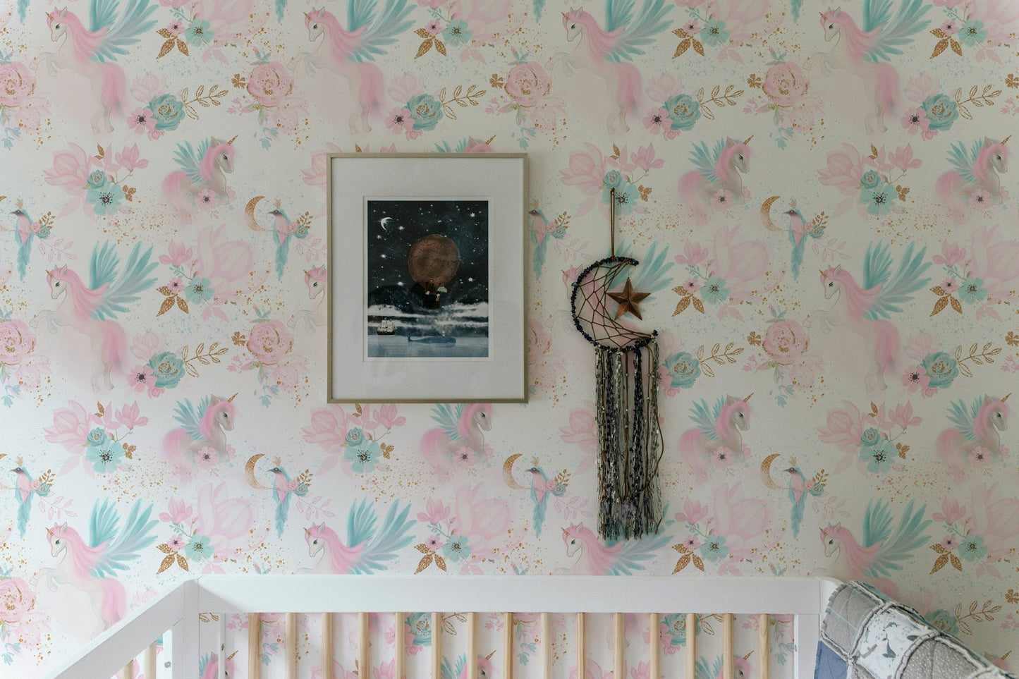 Pink and blue wallpaper pattern used as a backdrop for a white bed frame in kids bedroom.