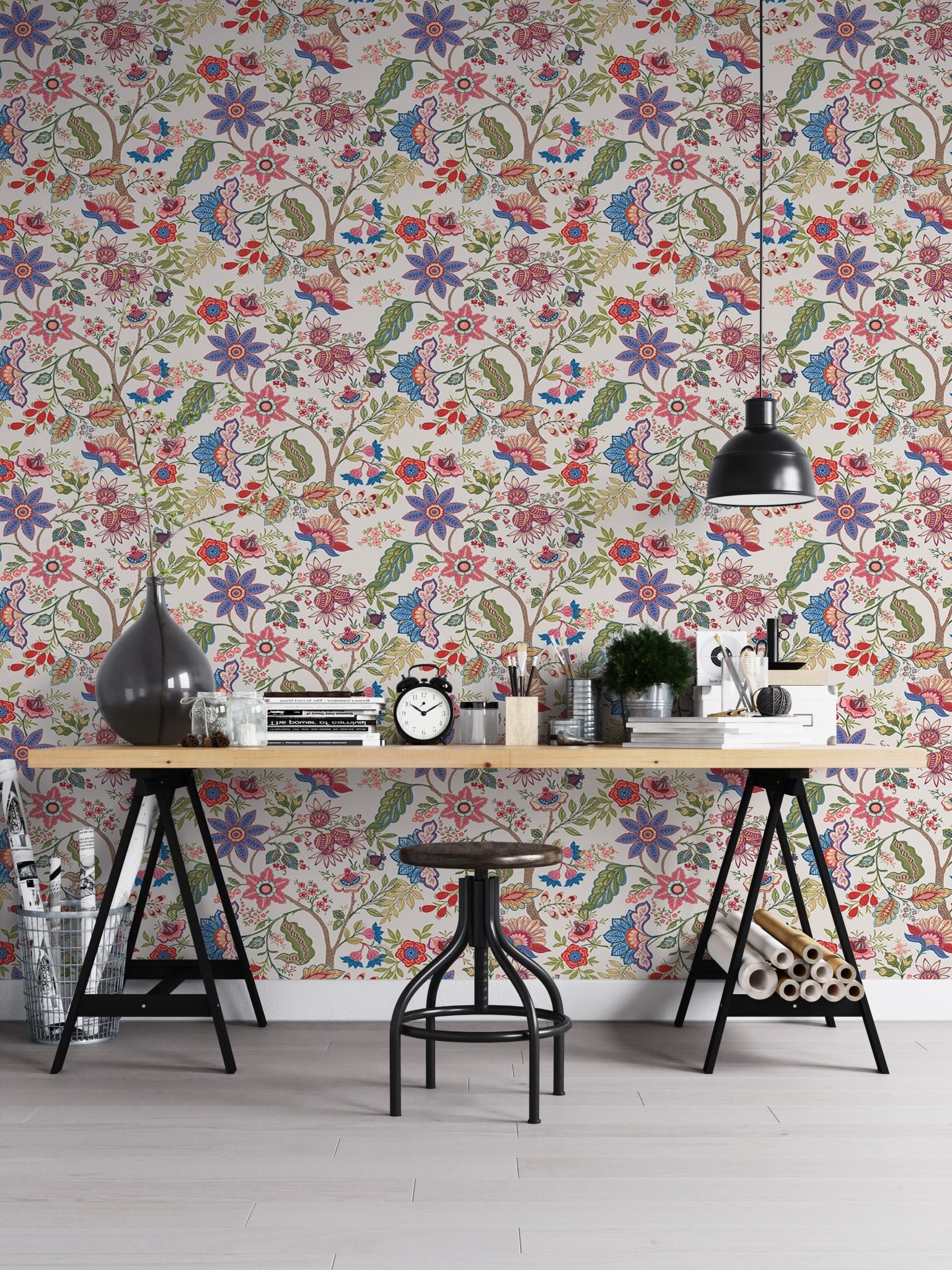 Industrial home office with vintage floral wallpaper and black metal furniture.