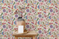 Decorative vase on a wooden stool with a floral jacobean pattern wallpaper.