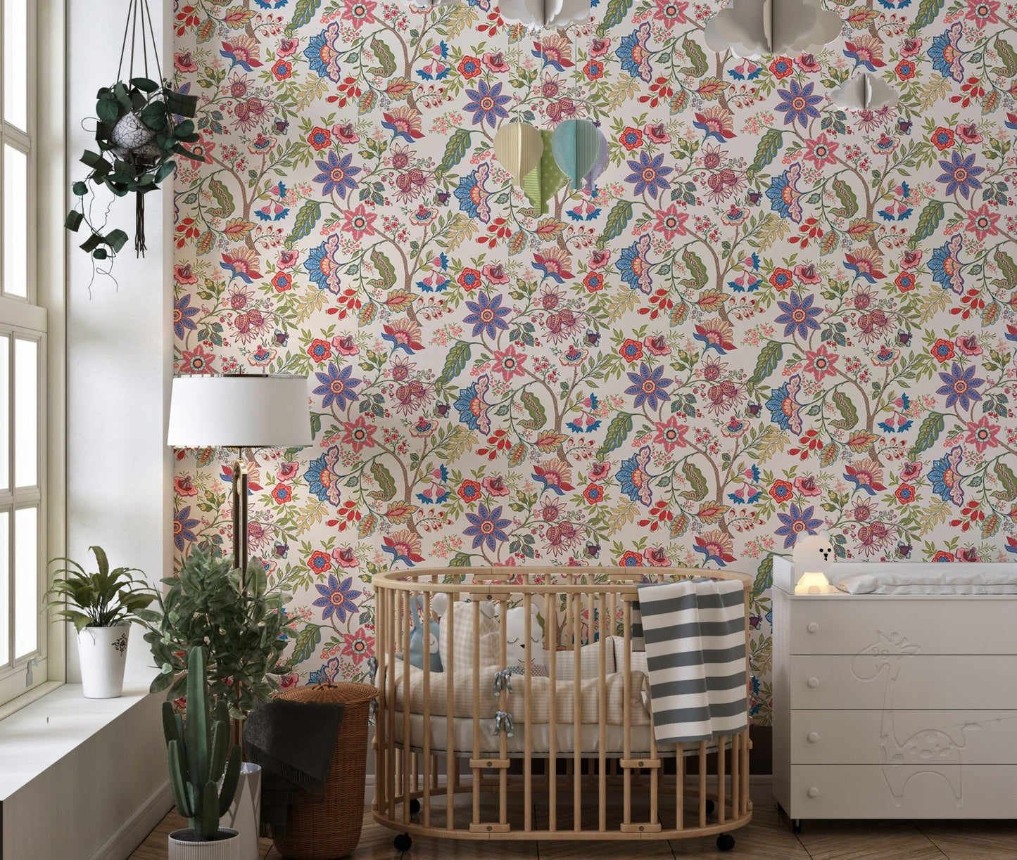 Sunlit nursery room featuring retro jacobean style wallpaper and indoor plants.