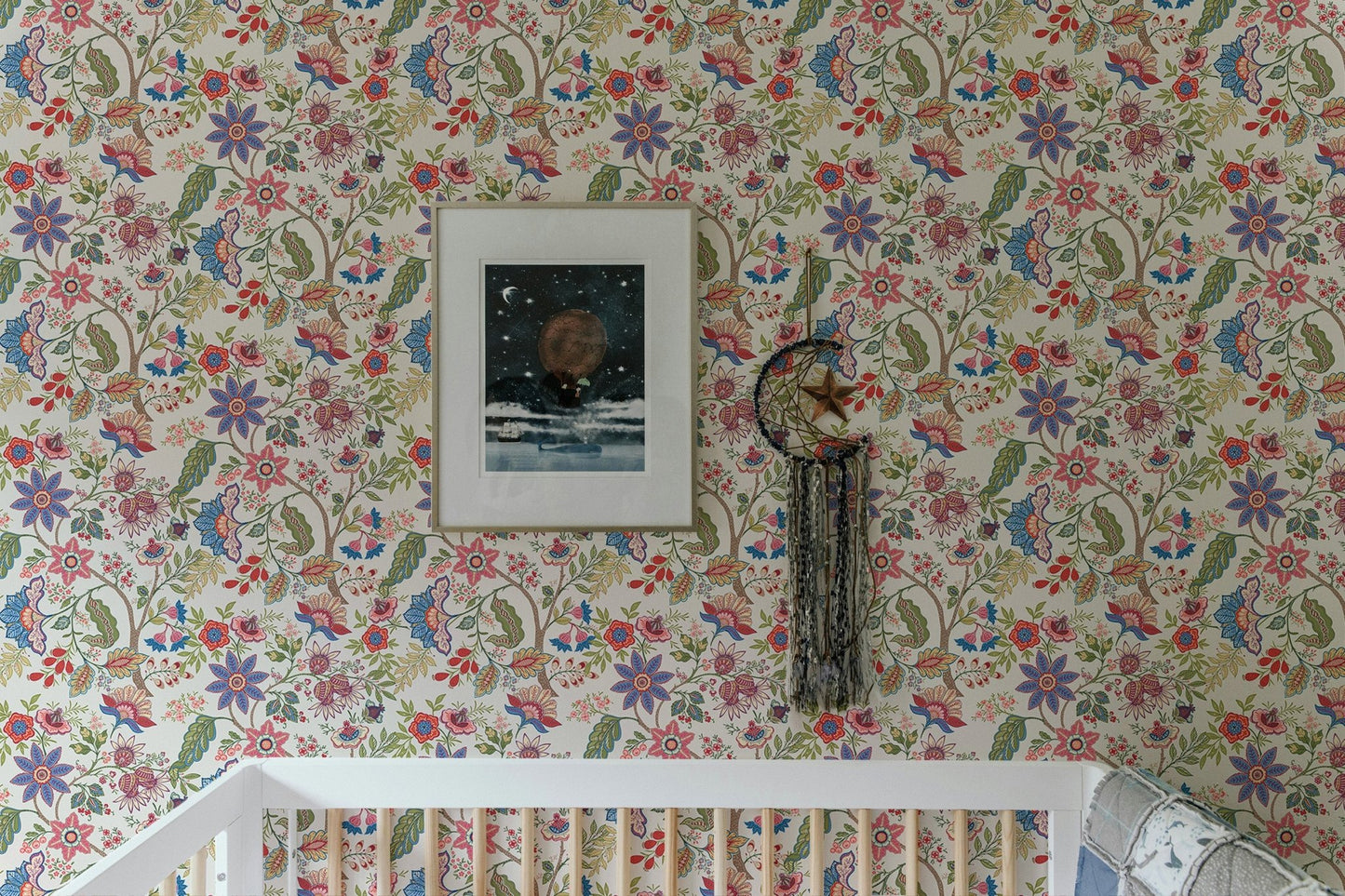 Nursery crib against fantasy flowers retro vintage jacobean embroidery style wallpaper.