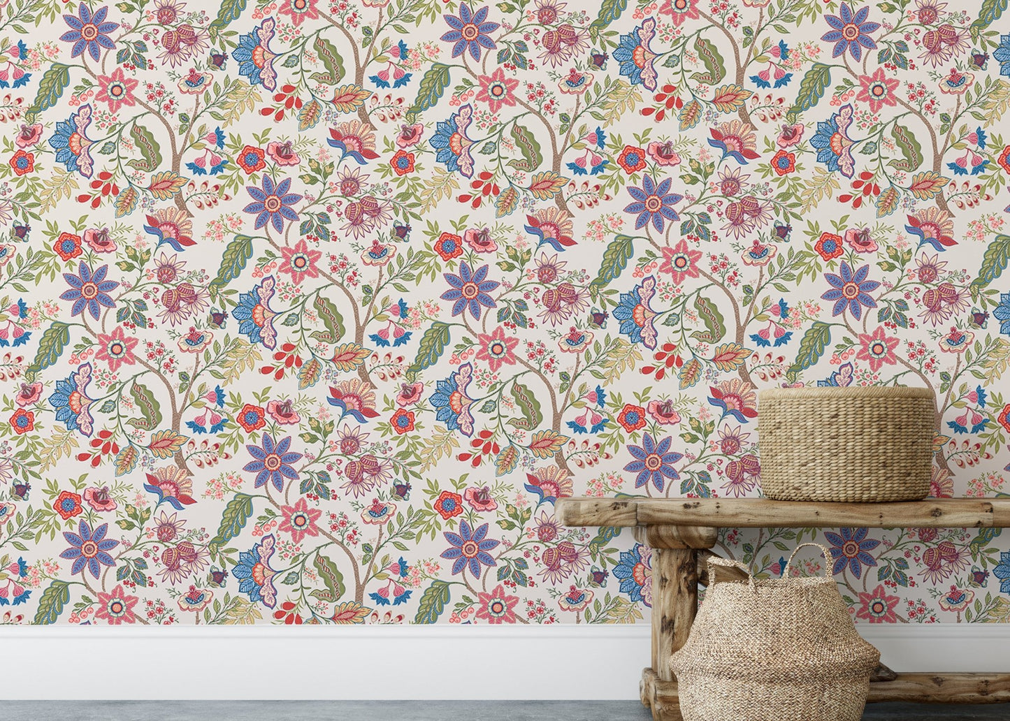 Rustic wooden bench placed in front of a multicolored floral pattern wallpaper.