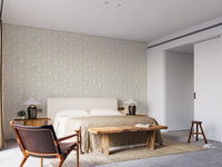 Repetitive face motif wall mural with flowing lines in bright bedroom.