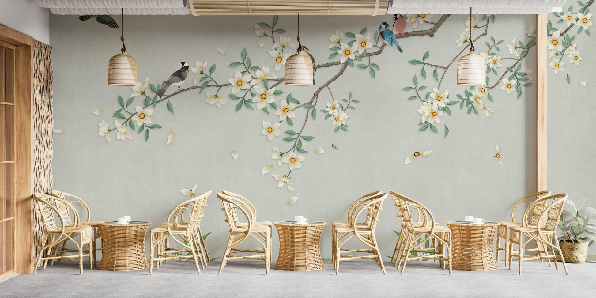 Green branch canopy wall mural behind a minimalist cafe seating arrangement.