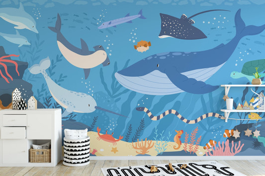 Sea life wall mural in a playroom featuring white storage cabinets.