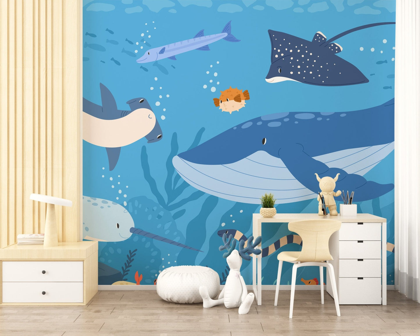 Blue fish wall mural in a study room with a white desk and wooden chair.
