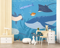 Blue fish wall mural in a study room with a white desk and wooden chair.