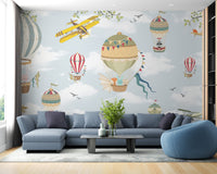 Blue sky wall mural with vintage yellow planes and hot air balloon in living room.