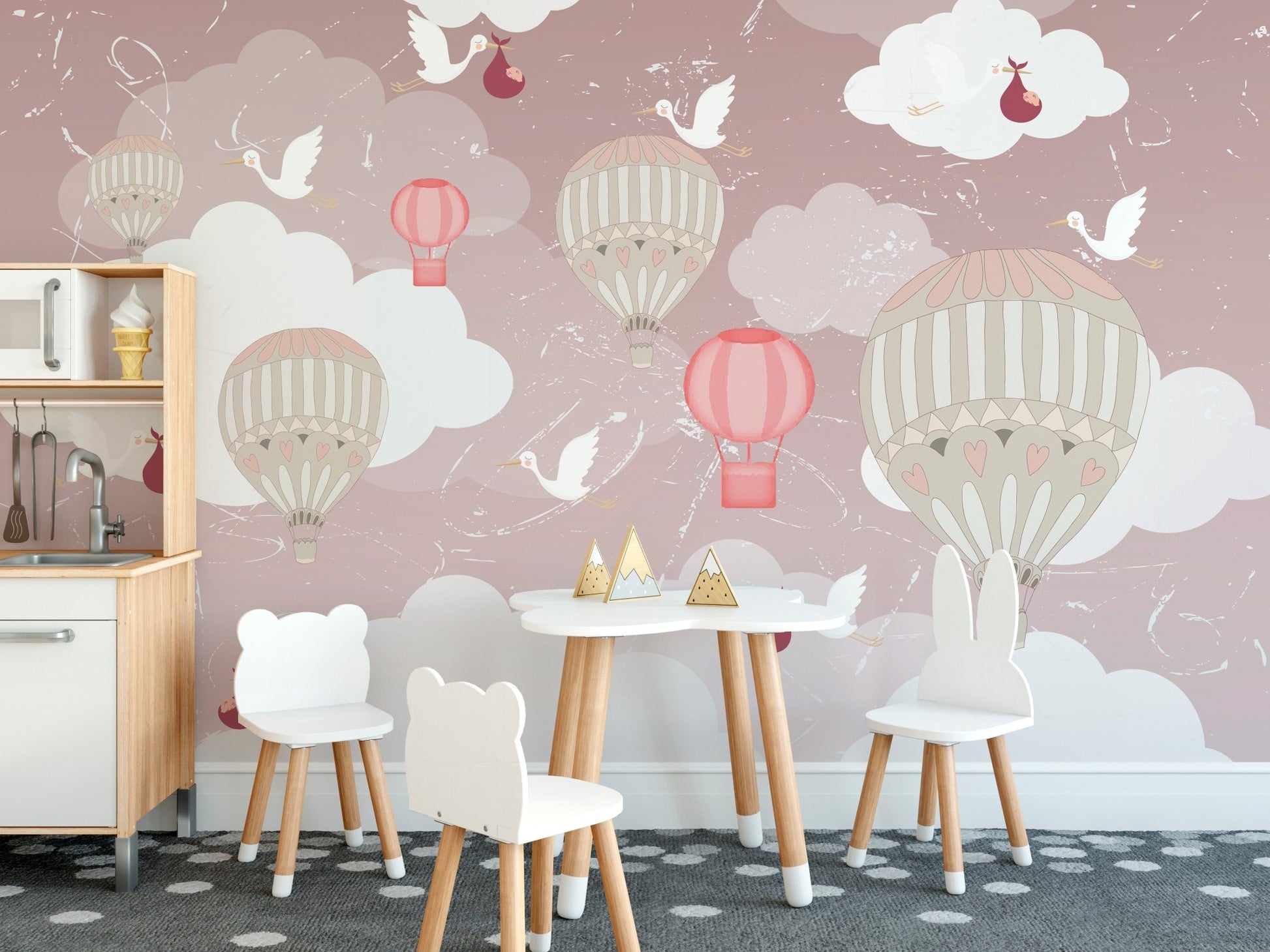 Dining area wall mural with floating balloons behind a small table and chairs set.