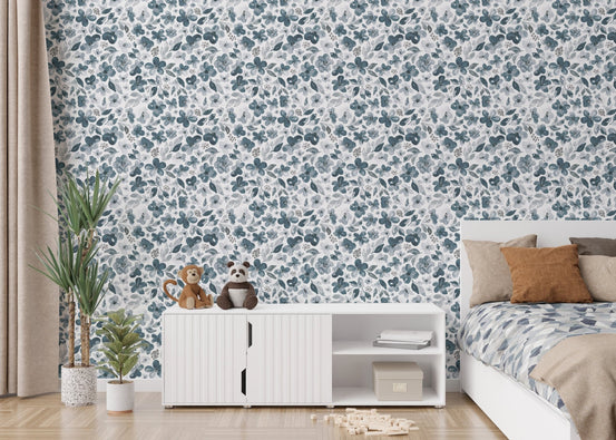 Floral bluish grey watercolor botanical wallpaper in a bedroom with a white cabinet.