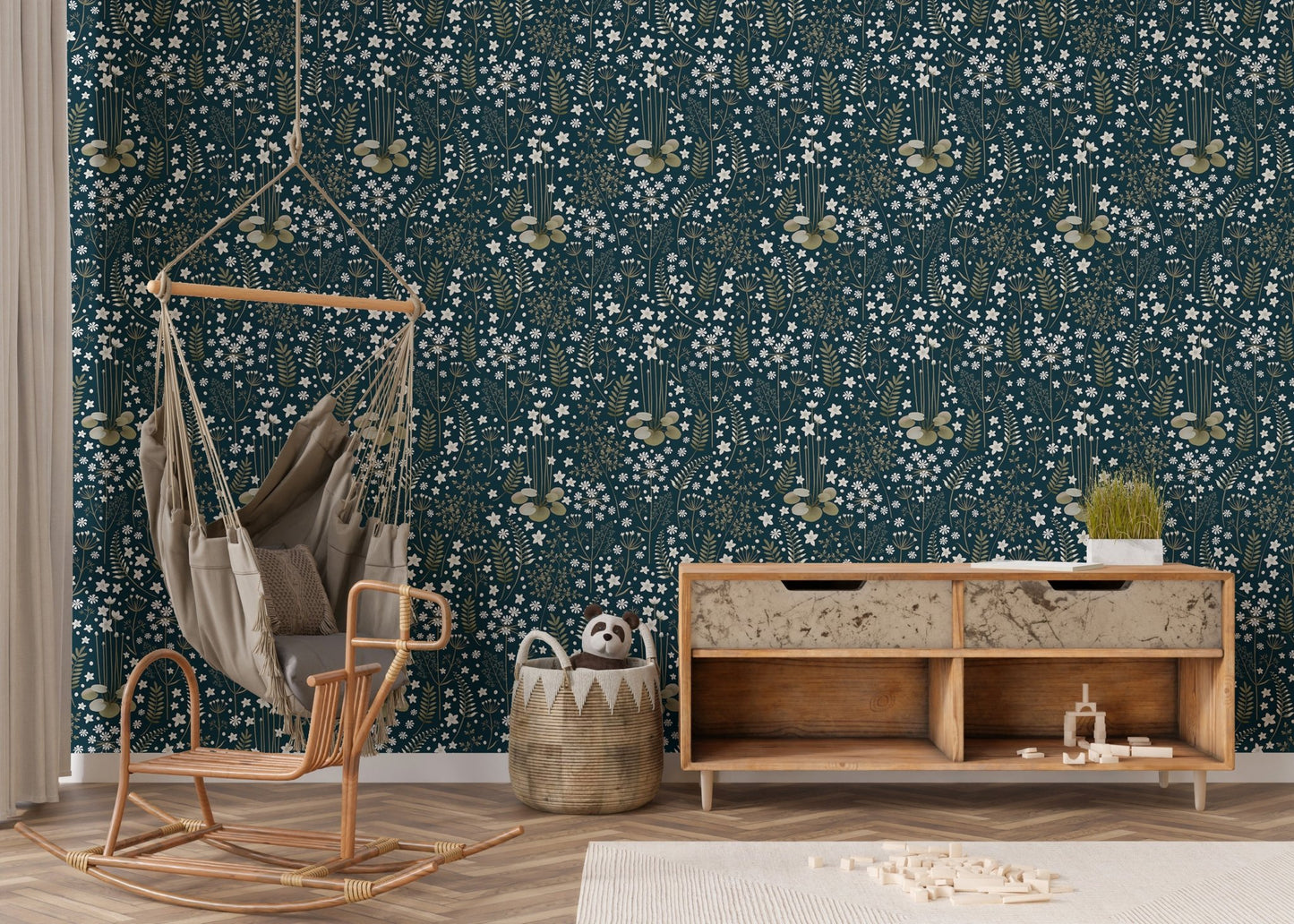 Botanical leaves wallpaper in a nursery with a hanging wicker chair and wooden floor.