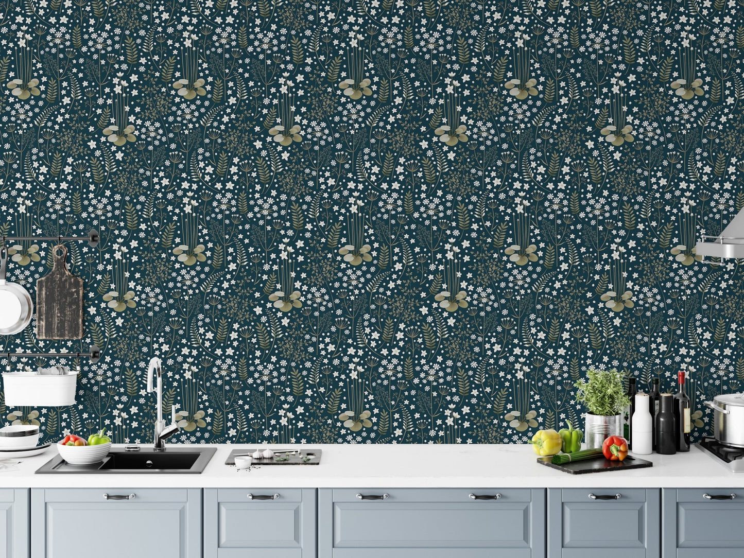 Dark blue floral wallpaper in a modern kitchen above grey cabinets.