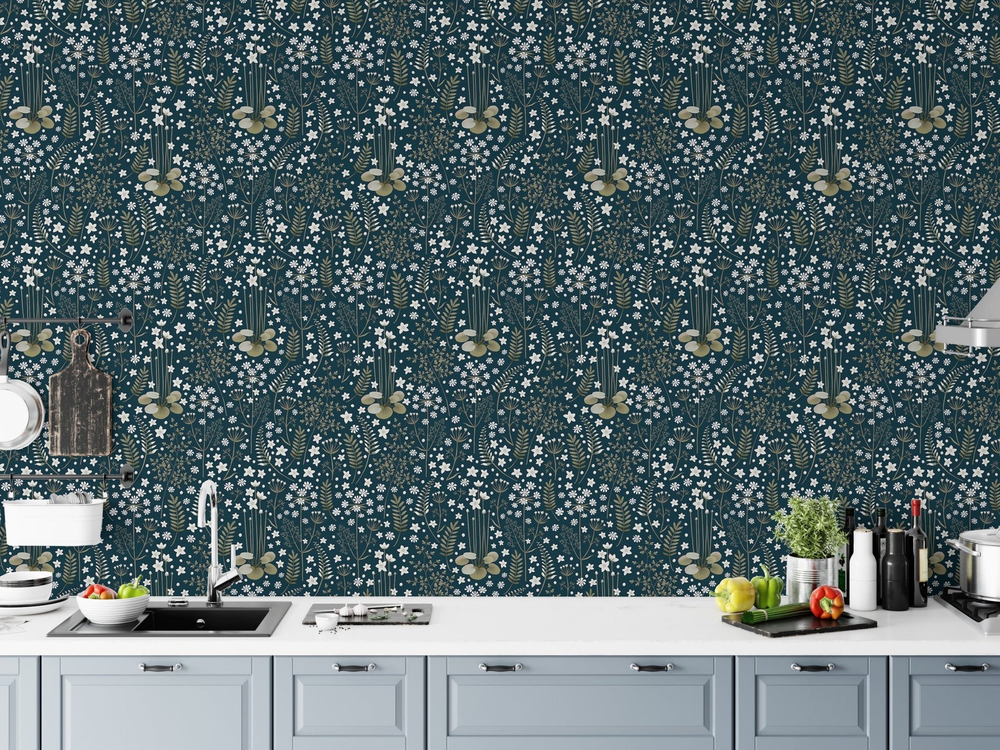 Dark blue floral wallpaper in a modern kitchen above grey cabinets.
