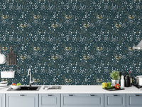 Dark blue floral wallpaper in a modern kitchen above grey cabinets.