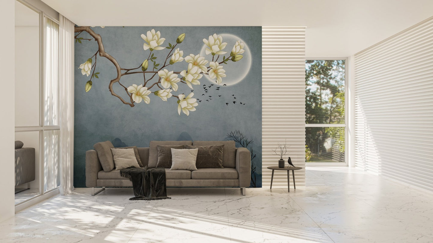 Blue Japanese floral wall mural behind a grey couch in a bright living area.