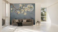 Blue Japanese floral wall mural behind a grey couch in a bright living area.