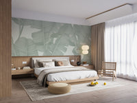 Floral seamless green banana leaves wall mural in a bedroom with wooden furniture.