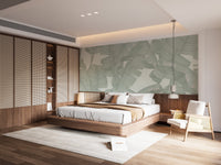 Tropical green leaf wall mural in a bedroom featuring a wooden headboard wall.