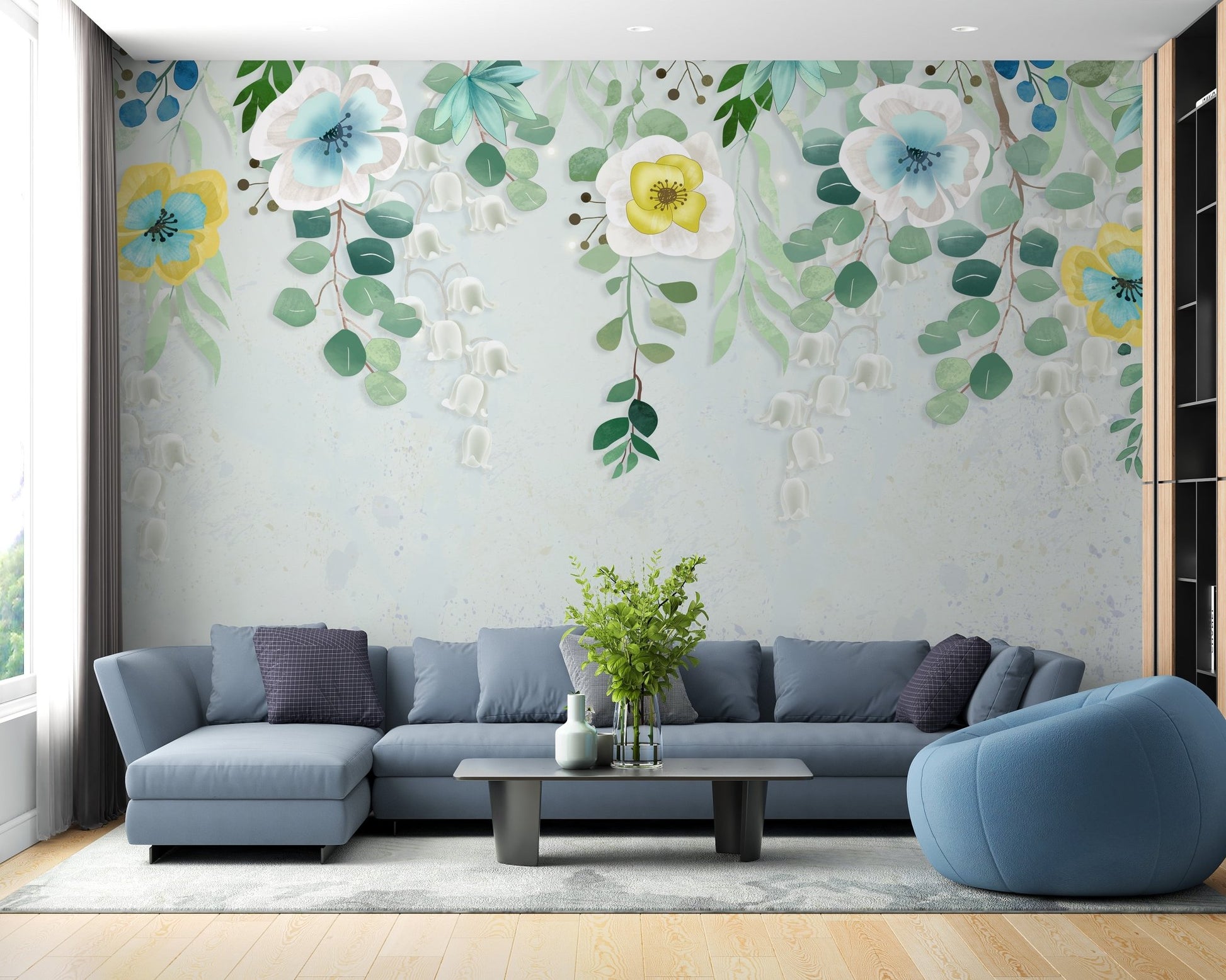 Blue sectional sofa paired with a soft watercolor flourishing wall mural.