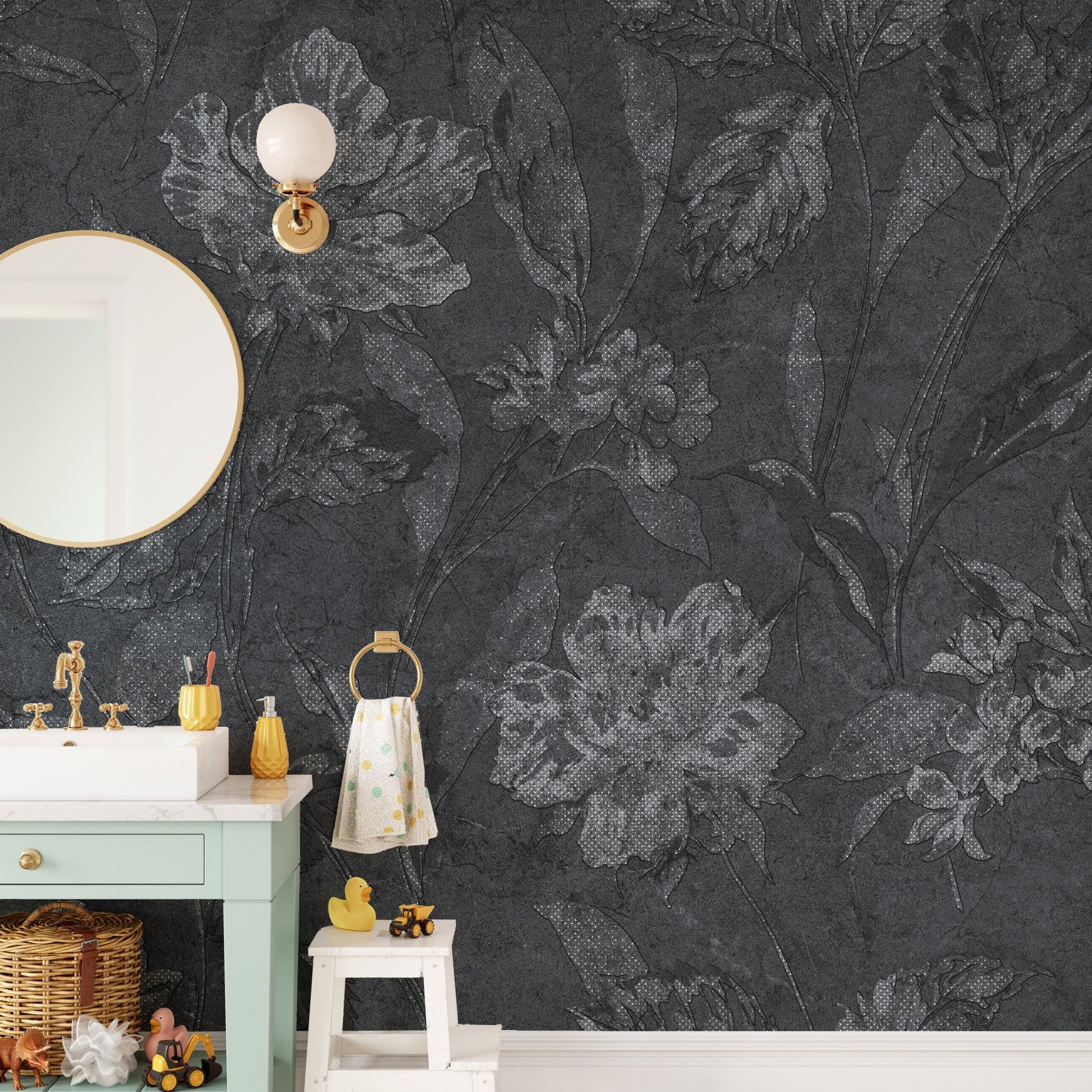Elegant black flower wallpaper in a small bathroom with a white basin and gold mirror.