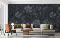 Sophisticated dark floral pattern wallpaper in a wide living space with a neutral sectional.